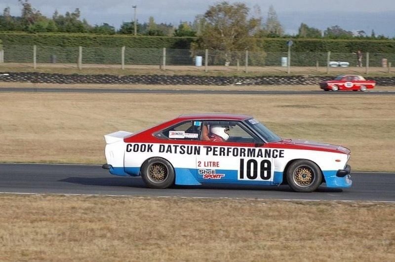 Lyn Hatton racing the Cook Datsun Performance car as number 108, red, white and blue, on a circuit