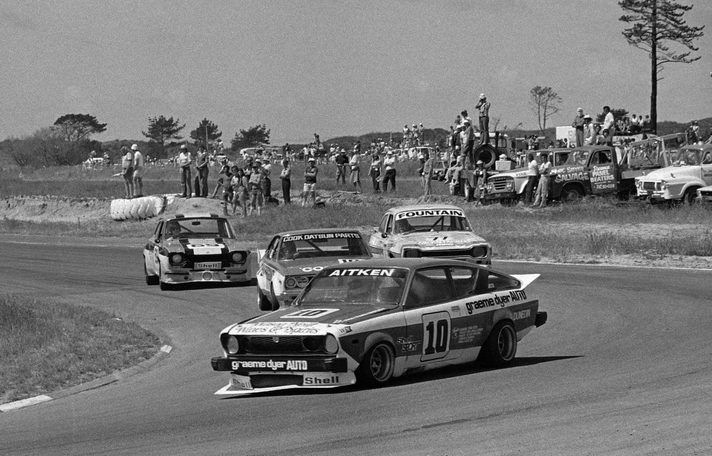 Grant Aitken's #10 leads Reg Cook's Datsun, Fountain's Escort and #69 through a bend
