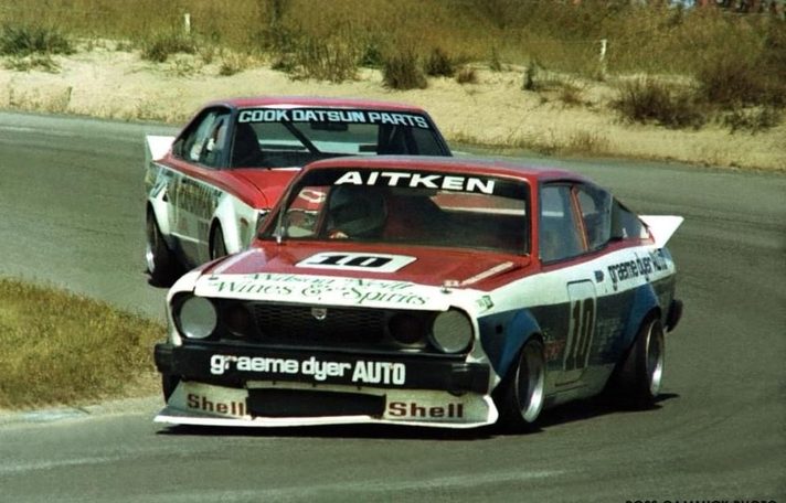 Grant Aitken's #10 leads the red-bonneted Cook Datsun