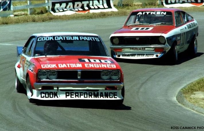 Reg Cook's red and white Datsun #100, Cook Datsun Engines on the bonnet, ahead of Aitken's #10