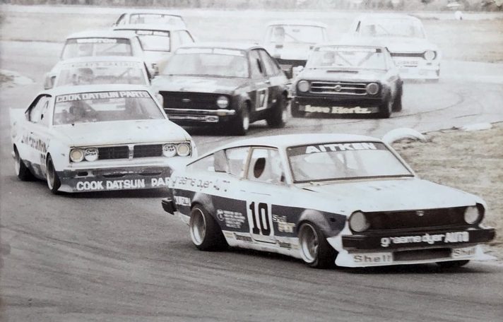 Grant Aitken's #10 leads Reg Cook's Datsun and a pack of saloons through a bend